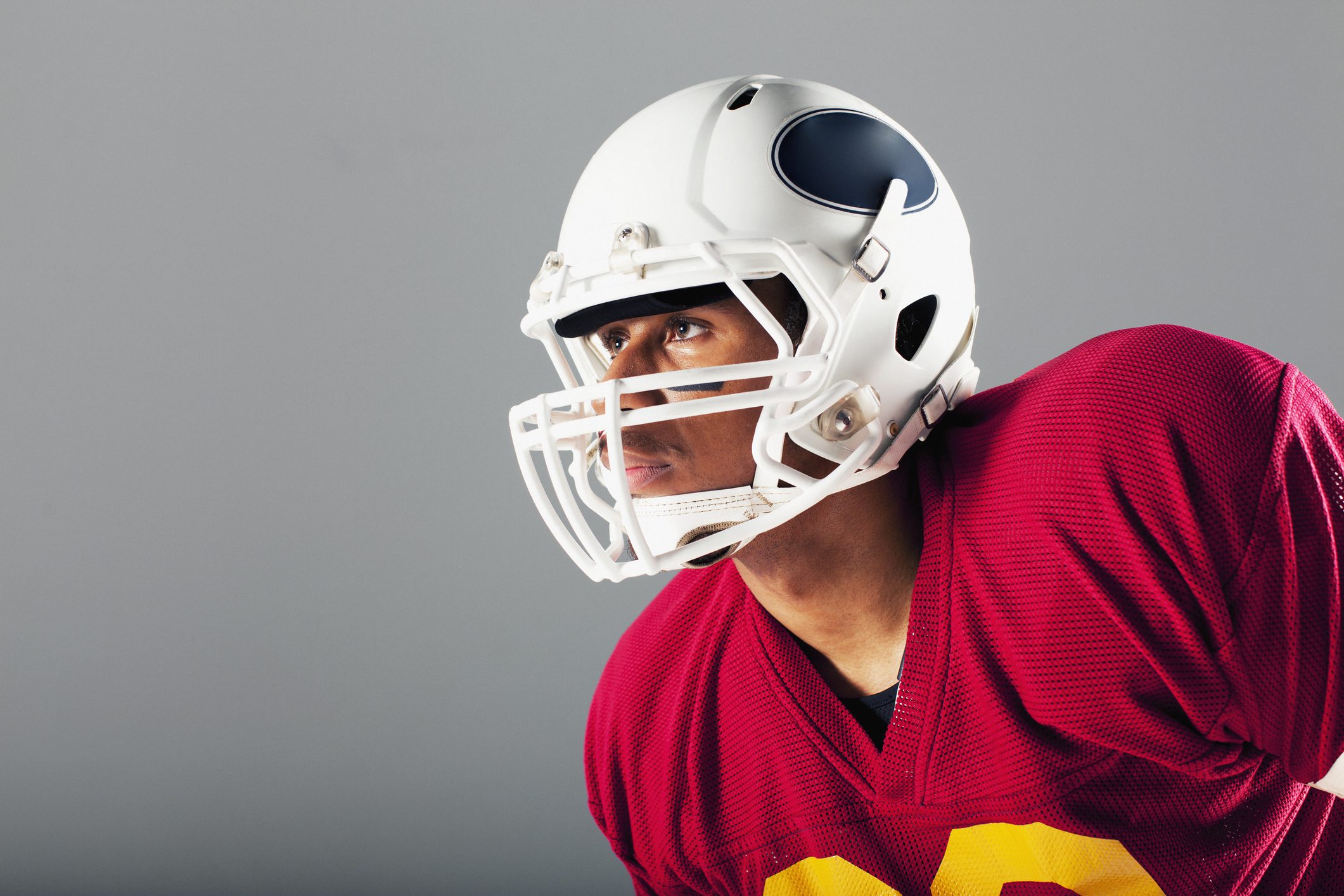 A football player in a white helmet and red jersey.
