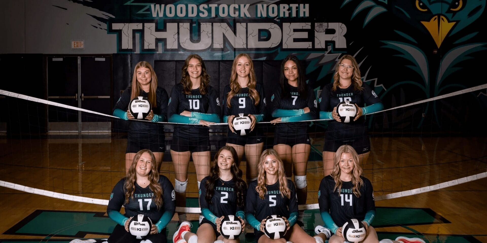 Woodstock North Thunder volleyball team posing with trophies.